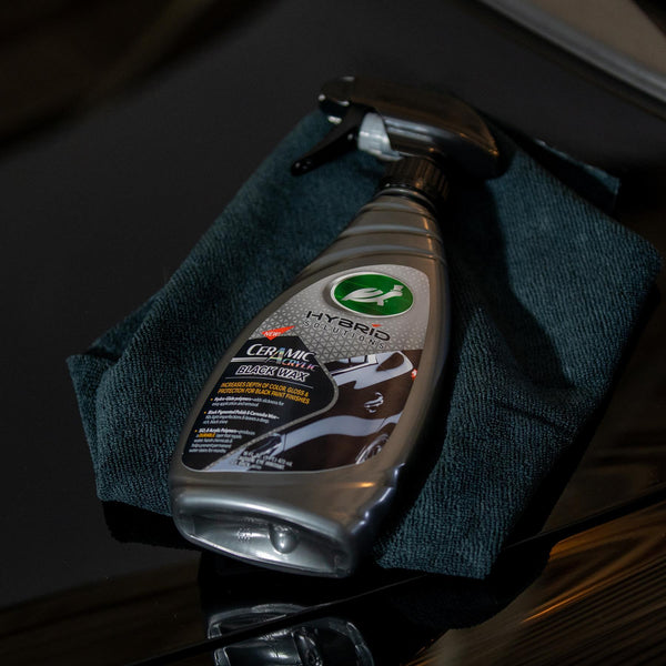 Turtle Wax Hybrid Solutions Ceramic Acrylic Black Wax on a dark blue microfiber cloth. Car detailing for black paint finishes.